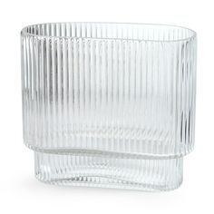 a clear glass vase sitting on top of a white table