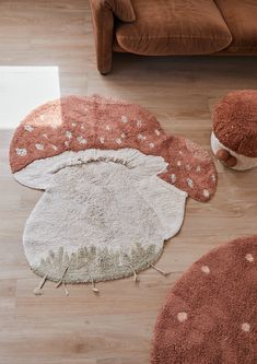 a living room with brown couches and rugs on the floor in front of it