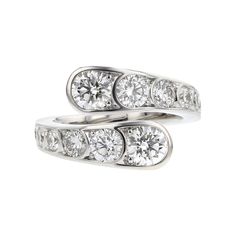 two white gold rings with diamonds on each side and one diamond set in the middle