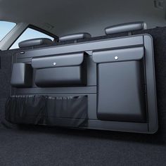 the back end of a car with its cargo compartment open and two seats folded down