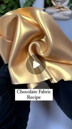 a person holding up a gold cloth with the words chocolate fabric recipe written on it