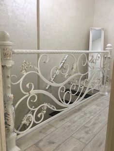 a white iron railing in the corner of a room