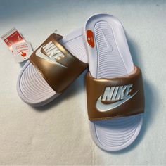 Victori One Slides White With Muted Gold Strap Ynf 13204, 13261 (7) Ynf 12740, 12843 (8) Ynf 12738 (9) Gold Casual Slip-on Slides, Casual Gold Synthetic Slides, Sporty Brown Slides For Summer, Nike Low-top Slides For Summer, Casual Gold Slides For Spring, Nike Sporty Slides For Spring, Nike Presto Women, Nike Flip Flops, Casual Logo