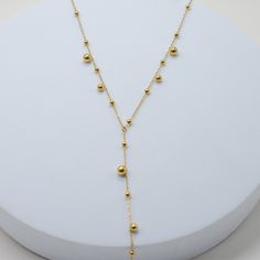 our Walking On A Dream Lariat makes an elegant statement for any occasion. with its playful design, it adds a stylish edge to your outfit, effortlessly capturing the eye of any crowd. 18k gold pvd over 316L stainless steel can be worn from 16-18" 4" lariat drop 3-5mm beads 1mm chain Modern Gold Lariat Necklace With Adjustable Chain, Gold Dangle Lariat Necklace For Parties, Adjustable Yellow Gold Long Drop Lariat Necklace, Adjustable Long Drop Gold Necklace, Modern Gold Lariat Necklace With Clavicle Chain, Trendy Gold Lariat Necklace With Adjustable Chain, Modern Gold Lariat Necklace With Long Drop, Modern Adjustable Gold Lariat Necklace, Minimalist Gold Drop Necklace For Party