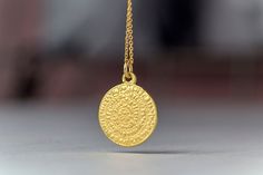 Solid gold phaistos disc necklace, ancient Greek necklace. This pendant was inspired by the ancient Greek Phaistos disc. The pendant is available in 14k yellow, white or 18k rose gold. You can purchase the charm with a 9k solid gold chain, a 14k solid gold chain or as a pendant only without chain. The pendant measures 1.7cm/0.7 inches. You can choose between a brushed/matte or shiny finish. Perfect gift for Valentine, Mother's Day or any other special occasion. Comes in a cute jewelry box. The P Amulet Style Yellow Gold Sterling Silver Coin Necklace, Amulet Sterling Silver Coin Necklace In Yellow Gold, Engraved 14k Gold Amulet Coin Necklace, Spiritual Yellow Gold Coin Necklace With Round Shape, Spiritual Sterling Silver Coin Necklace In Yellow Gold, Spiritual Yellow Gold Sterling Silver Coin Necklace, Yellow Gold Sterling Silver Coin Necklace, Yellow Gold Sterling Silver Round Coin Necklace, Round Amulet Necklace Stamped 14k