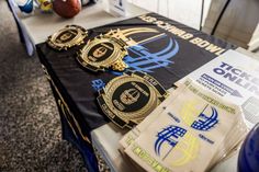 the table is set up with badges and other items for sports fans to use on their shirts