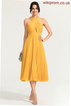 a woman in a yellow dress posing for the camera with her hands on her hips