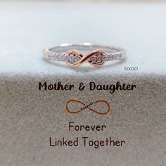 With a meaningful message card included, this ring is the perfect gift for either mom or daughter. It also serves as a reminder that the love between mother and daughter is forever linked together. CARD MESSAGE Mother & Daughter Forever Linked Together. SPECIFICATIONS Size: US 5-10 Stone: AAA Grade Cubic Zirconia Metal: 925 Sterling Silver WHAT'S IN THE BOX 1*Mother Daughter Ring 1*Full-designed gift card 1*Silver polishing cloth 1*Free box If you have any questions about the ring, please contac Mom And Daughter Rings, Hypoallergenic Promise Ring For Mother's Day, Mother's Day Infinity Adjustable Rings, Personalized Adjustable Infinity Rings, Adjustable Infinity Ring For Mother's Day, Meaningful Rings For Wedding And Mother's Day, Meaningful Wedding Rings For Mother's Day, Wedding Rings For Mother's Day, Gift Sterling Silver Infinity Stackable Rings