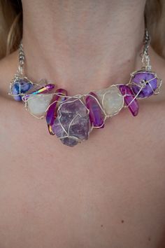 A multi stone statement necklace featuring silver plated wire wrapped around a variety of stone such as rainbow aura quartz, rough purple fluorite , rainbow moonstone and other beads. The pendant is around 10cm in length and 4cm in width. The statement pendant hangs on a stainless steel silver 5mm curb chain at a desired length (refer to pendant length and necklace fit in last photo) Comes with a 5cm extension chain. Custom requests accepted if you would like to see a combination of particular s Suede Choker Necklace, Ethereal Jewelry, Amethyst Bangle, Crescent Moon Jewelry, Rainbow Aura Quartz, Stone Statement Necklace, Crystal Statement Necklace, Rainbow Aura, Purple Fluorite