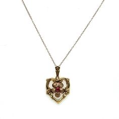 "Vintage 1940s 10k Yellow and Rose Gold Retro Heart Pendant Necklace. The Retro period 10k gold heart has engraved flower details with a rose gold flower center with a lab created red gemstone in the center. The heart measures 1.12\" tall and .75\" wide including the bail. The length of the 10k gold chain is 18 3/4 inches long. The weight of the necklace is 2.22g. This is a true vintage piece of jewelry." Vintage 14k Gold Jewelry For Valentine's Day, Vintage Charm Jewelry For Valentine's Day Formal, Vintage 14k Rose Gold Necklaces, Vintage Rose Gold 14k Stamped Jewelry, Vintage Heart Cut Jewelry For Formal Occasions, Vintage Charm Jewelry For Valentine's Day Formal Occasion, Victorian Birthstone Necklace For Anniversary, Formal Vintage Charm Jewelry For Valentine's Day, Antique Heart Necklace For Valentine's Day Wedding