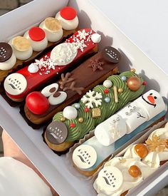 a box filled with lots of different types of cakes and pastries on top of each other