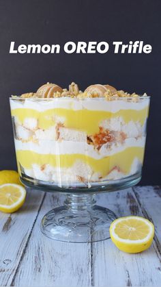 a lemon trifle in a glass dish with sliced lemons around the edges and on top