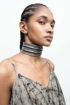 a woman with braids wearing a choker