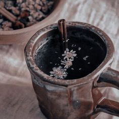 two mugs with cinnamon sticks sticking out of them