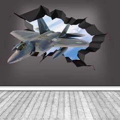 a fighter jet flying through the air through a hole in the wall with wood flooring