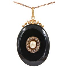 Memories Keeper Superb Victorian period 1880 ca, large carved Onyx locket pendant with scroll open work at the top side further embellished with centre – not nucleated Natural Sea Pearl – nestled into a halo of Rose cut Diamonds for a dramatic visual look Made of 18 Kt gold including the back window frame Onyx is skilfully hand carved, natural pearl is slight off shape but pretty large in size ( 8 x 6.6 mm.) outstanding in its individuality for goldish colour and unique shape prizing rare silky sheen and natural iridescence proper to natural pearls Rose cut Diamonds for approx .45 CT - by spread Window is foiled with Purple colour Silk , original glass , all in perfect order and kept in pristine condition Antique mourning jewellery is chic and fashionable easy wear on jeans or evening outf Black Locket, Victorian Period, Pearl Rose, Onyx Necklace, Sea Pearl, Evening Outfits, Water Pearls, Natural Pearl, Old Jewelry