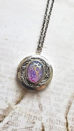 Crystal Purple Opal Necklace About The Purple Opal Stone: ~ Lavender Purple Synthetic Lab Created ~ Opal Cabochon Oval Shape Chain: ~ Antiqued Silver CHOOSE YOUR CHAIN LENGTH during checkout ☻More FIRE OPAL JEWELRY: https://www.etsy.com/shop/FashionCrashJewelry/search?search_query=dragons+breath&order=date_desc&view_type=gallery&ref=shop_search ☻Link to The ENTIRE SHOP: https://www.etsy.com/shop/FashionCrashJewelry?ref=shopsection_shophome_leftnav&ga_search_query=crystal%2Bnecklace Our Motto ~ H Purple Crystal Jewelry, Spiritual Silver Oval Pendant Locket Necklace, Handmade Silver Spiritual Locket Necklace, Spiritual Handmade Silver Locket Necklace, Silver Spiritual Locket Necklace, Handmade Unique Silver Locket Necklace, Bohemian Silver Keepsake Jewelry, Goddess Oc, Solar System Bracelet