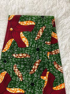 This green and red African Fabric is high quality African print made from 100% cotton and it's 45 inches wide. It is used for making African Clothing, African quilts, & For Home decoration. FYI: Print is Double sided. The listing is for 1, 6 yards and Headwrap Each piece of fabric measures:  36in by 45in for 1 yard 216in by 45in for 6 yards 72in by 22in for Head wrap If you purchase more than one yard, you will receive one continuous piece. *If you require more than what I have listed, feel free African Quilts, Clean And Press, African Prints, Ankara Fabric, Green And Red, African Fabric, Head Wrap, African Clothing, African Print