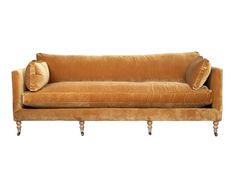 a brown couch with two pillows on it's back and one arm resting on the other end