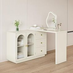 a white desk with two drawers and a mirror on the top shelf next to it