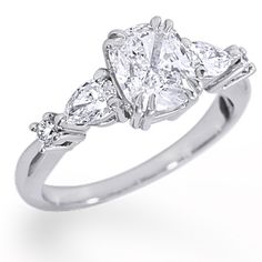 a three stone diamond ring on a white background