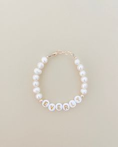 Beautiful pearl name bracelet ❤️A Single bracelet and a custom word of your choosing. These 14k gold filled beaded bracelets are made from high-quality, durable tarnish resistant beads and gold findings This Pearl bracelet is the perfect and affordable accessory for any little sweetie. Purchase multiples to layer them on! These make GREAT baby photo prop accessories. Can be used as an Ankle Bracelet. Customizable worded bracelet stacks. Perfect for birthdays, gender reveals, baby announcements, Classic Personalized Beaded Bracelets For Gifts, Classic Personalized Beaded Bracelets As Gift, Birthday Bracelets With Name On Round Beads, Classic Personalized Beaded Bracelets For Everyday, Classic Customized Name Bracelet Adjustable, Classic Adjustable Customized Name Bracelet, Classic Customized Adjustable Name Bracelet, Birthday Beaded Name Bracelets With Round Beads, Birthday Beaded Bracelets With Name