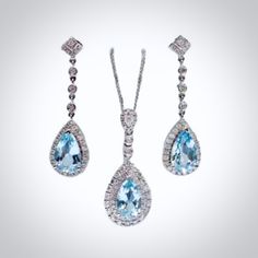 Delicate and classy, this exquisite necklace and earrings set was designed in art deco vintage inspired style. The bright rhodium plated setting perfectly enhances the intricate detailing and conveys a modern take on old elegance. The pieces are adorned by flawlessly faceted cubic zirconia in a vibrant aqua blue color that captures the light from every angle with a perfectly translucent appeal, sparkling beautifully. Necklace: The pendant measures 1.4" (approx. 3.6cm) and hangs on a delicate cab Elegant Pendant Jewelry Sets, Elegant White Gold Teardrop Jewelry Sets, Elegant Formal Jewelry Sets With Teardrop Pendant, Elegant Teardrop Pendant Jewelry Sets For Formal Occasions, Elegant Pendant Jewelry Sets For Formal Occasions, Elegant Formal Jewelry Sets With Pendant, Classic Teardrop Jewelry Sets For Formal Occasions, Elegant Blue Jewelry Sets With Diamond Accents, Elegant Blue Diamond Jewelry Sets