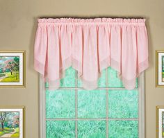 a window with pink curtains and pictures on the wall