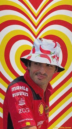 a man wearing a red and white hat standing in front of a heart shaped background