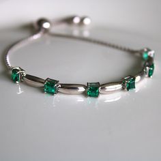 This sterling silver 3 mm Emerald Gemstone Bolo Bracelet is simply elegant. She'll love the versatility this bracelet offers as it pairs amazingly with fine fashion and casual wear. The bracelet is comfortable and easy to adjust to your liking with the pull tie and ball clasp. A thoughtful gift for a May Birthday and a variety of other occasions and events. Explore All Of Our Timeless Jewelry: https://www.etsy.com/shop/JOHNWESHDESIGNS All JohnWeshDesigns jewelry is handcrafted and designed to me Silver Birthstone Bracelet For Formal Occasions, Formal Silver Bracelet With Birthstone, Elegant Cubic Zirconia Bracelet With Birthstone, Adjustable Fine Jewelry Bracelets With Stones, Elegant Sterling Silver Bracelets For May Birthstone, Silver Birthstone Bracelets For Formal Occasions, Fine Jewelry Bracelets With Stones, Silver Bracelet For Anniversary With May Birthstone, Silver Sterling Bracelets For May Birthstone