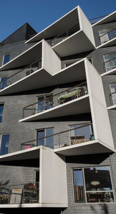 an apartment building with balconies on the second floor