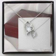 Give a loving gift that will make her heart melt! This dazzling Forever Love Necklace features a polished heart pendant surrounding a flawless 6.5mm cubic zirconia, embellished with smaller crystals adding extra sparkle and shine. The pendant is crafted in 14K white gold finish and dangles from an adjustable cable chain secured with a lobster clasp. DIMENSIONS: ▶ 14K white gold finish ▶ Adjustable cable chain 18" - 22" ▶ 6.5mm round cut cubic zirconia ▶ Height 0.8" (2.2cm) Width 0.7" (1.8cm) PERFECT FOR: Birthday Gift, Thanksgiving Day Gift, Christmas Gift, New Years Gift, Best Friend Gift, Family Gift, Valentines Day Gift, Mother Necklace, Daughter Necklace, Promise Necklace, Daily-wear Necklace. Crystal Jewelry For Valentine's Day Gift, Crystal Jewelry Valentine's Day Gift For Her, Crystal Jewelry For Valentine's Day Gift For Her, Valentine's Day Crystal Jewelry Gift For Her, Dazzling Heart-shaped Jewelry For Gifts, Dazzling Heart-shaped Jewelry Gift, Dazzling Heart Shaped Jewelry For Gifts, Elegant Heart Necklace With Sparkling Stones For Gift, Heart-shaped Cubic Zirconia Jewelry Gift