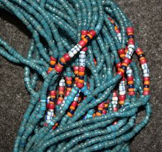 "Antique Necklace 579. Authentic Konyak Naga Long \"Royal\" Chief's Clan, Old blue Glass Trade Bead Necklace with Macrame Clasp and Attached Old Chank Shell Adornment Showing Increased Status. \"Royal\" center of special chevron, mustard, white heart and other beads usually seen in higher status collars, bibs and belts. Excellent condition. The piece has 45 strands of beads and is 32 \"long. Beads all acquired in trade, from Europe and India, from late 19th to mid 20th century. Shell, from the I Festival Blue Beaded Necklaces With Colorful Beads, Traditional Blue Beaded Bracelets For Festivals, Traditional Blue Beaded Necklaces, Traditional Beaded Necklaces With Spacer Beads For Festival, Artisan Blue Beaded Necklaces For Festivals, Handmade Blue Beaded Necklaces For Festivals, Bohemian Blue Beaded Bracelets For Festivals, Blue Polished Beaded Bracelets For Festivals, Handmade Blue Beaded Bracelet For Festivals