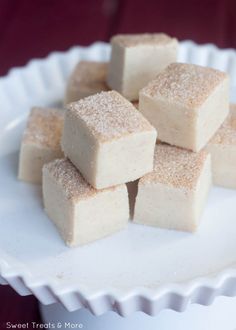 several pieces of cake sitting on top of a white plate with powdered sugar over it