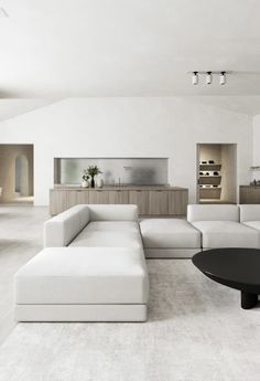 a living room filled with furniture and white walls