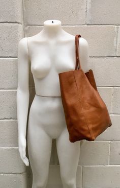 Large tote leather bag in dark CAMEL BROWN. Saddle brown shoulder bag. Tan color natural GENUINE leather. Large enough for books or a laptop, tablet, cosmetics bag etc. Leather shopper. The inside of the bag is not lined (although properly finished!) . We added a small leather pouch on the inner part of the bag (4th pic) The bag can be closed by 2 leather straps attached to each side. Excellent quality soft but strong genuine leather. Width upper part: 41cm - 16 inch Height: 38 cm - 15 inch This Dark Tan Leather Bag For On-the-go, Modern Brown Shoulder Bag For Shopping, Brown Modern Shoulder Bag For Shopping, Everyday Light Brown Rectangular Hobo Bag, Brown Double Handle Shoulder Bag For Everyday, Brown Satchel With Leather Handles For Shopping, Rectangular Brown Hobo Bag With Soft Leather, Brown Soft Leather Rectangular Hobo Bag, Modern Brown Tote Shoulder Bag