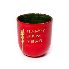 a red cup with happy new year written in gold on the outside and inside it