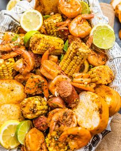 shrimp and corn on the cob with lime wedges