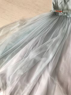 "Hands down one of the sweetest and coolest party dresses ever! That ice blue is just ❄️❄️❄️ And let's talk about that neckline! A X-front which ends in a nipped in waist. The metallic speckled material makes it that much more special. Full full full circle skirt done in silk, tulle and organza. Sooooooooooooo perfect! Condition: Very good. Slight yellow patch on back bodice which is barely noticeable. See second last photo. Fully lined. Bust 31\" Waist 24\" Length 44\" This item is clean and re Fitted Skirt For Summer Prom, Fitted Light Blue Tulle Dress, Light Blue Tulle Skirt Dress For Summer, Light Blue Tulle Summer Dress, Light Blue Tulle Dress For Summer, Chic Summer Skirt For Prom, Fitted Skirt For Spring Prom, Light Blue Tulle Party Dress, Blue Tulle Dress For Summer