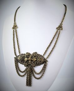 Reasonable offers are always considered  Gorgeous Victorian floral brass festoon tassel necklace. Beautiful draping. Chain measures 16 inches with center ornament measuring 3 inches wide and 2.75 inches long, including tassel.  Circa 1880-1900 Great vintage condition - some surface wear, as seen in photos. Will leave cleaning to buyer's discretion, as many collectors prefer the original patina. Please feel free to contact me with any questions. :) Victorian Style Metal Necklace With Antique Finish, Antique Gold Victorian Dangle Jewelry, Vintage Bronze Brass Chain Necklace, Elegant Metal Necklaces With Antique Finish, Elegant Metal Necklace With Antique Finish, Victorian Antique Finish Metal Necklace, Victorian Style Antique Finish Metal Necklace, Victorian Brass Jewelry With Adjustable Chain, Victorian Brass Necklace With Intricate Design