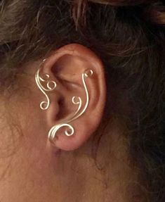 a woman's ear is shown with an intricate design on it