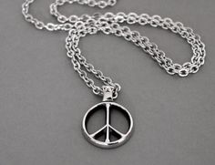 Groovy Peace Sign Necklace that will turn heads every where you go.  It has a tailored look and the pendant is nicely made in that classic Hippie style.  There is even a star at the top of the pendant bail.   Made with all Stainless Steel components and hypoallergenic, this necklace will be your favorite in no time. - Details: Peace Sign Pendant, 1.25 inches long and thick at 1/8 inch, beautifully cast in Stainless Steel -  Stainless Steel Flat Cable chain with Lobster Clasp - Pendant is Flat on Vintage Stainless Steel Necklaces, Vintage Stainless Steel Jewelry For Everyday Wear, Vintage Jewelry With Peace Sign For Gift, Vintage Jewelry With Peace Sign As Gift, Vintage Peace Sign Jewelry Gift, Vintage Round Necklace For Everyday, Vintage Round Everyday Necklaces, Vintage Everyday Round Necklace, Vintage Everyday Necklace