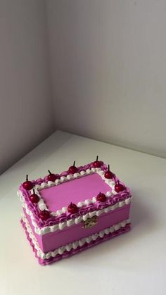 a pink and white cake sitting on top of a table