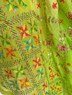 This elegant traditional Green Bridal Phulkari Dupatta is expertly crafted from Pure Chinon Silk, with Gotta Patti and phulkari hand embroidery all over. The perfect choice for weddings, sangeet, jaago, and chunni ceremonies. Material: Pure silk chinon Work: Silk thread phulkari handwork, all over gotta patti work Pattern: Floral Size: Full Size 2.5 meters Dispatched in 1-3 business days Product Note:​ This is a handcrafted product from artisans and producer groups and due to the nature of the p Green Kurta With Dupatta For Festival, Green Salwar Kameez With Chikankari Embroidery In Raw Silk, Bohemian Green Salwar Kameez With Cutdana, Bohemian Pista Green Salwar Kameez With Resham Embroidery, Green Kurta With Traditional Drape For Festival, Bohemian Green Kurta With Motifs, Green Chikankari Embroidered Traditional Wear For Festive, Green Salwar Kameez With Chikankari For Navratri, Pista Green Chanderi Traditional Wear With Dori Work