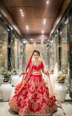 a woman in a red and gold bridal gown