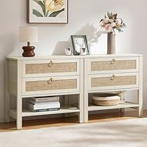 a white sideboard with drawers and baskets on it next to a vase filled with flowers