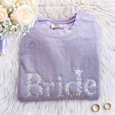 Bridal Gift, Bride Sweatshirt, Engagement Gift, Custom Bride Sweater, Bridal Shower Gift, Custom Bride Gift, Bride To Be Sweater, Future Mrs Sweater, Just Married Gift, Custom Mrs Shirt, Bachelorette Gift, Gift Idea For Her, New Mrs Gift 🎩 𝑷𝒓𝒐𝒅𝒖𝒄𝒕 𝒂𝒏𝒅 𝑩𝒓𝒂𝒏𝒅 𝑫𝒆𝒕𝒂𝒊𝒍𝒔: Brand: Comfort Colors® 9.5 oz., 80% ring spun USA cotton, 20% polyester Preshrunk, soft-washed, garment-dyed fabric Made with 80% sustainably and fairly grown USA cotton and sewn with USA cotton thread 🎩 𝑷𝒆𝒓𝒔𝒐𝒏𝒂𝒍𝒊𝒛𝒂𝒕𝒊𝒐𝒏 𝑮𝒖𝒊𝒅𝒆: 𝗦𝘁𝘆𝗹𝗲 𝗢𝗽𝘁𝗶𝗼𝗻𝘀: T-shirt: Short sleeves Sweatshirt (crewneck): No hood 𝗘𝗺𝗯𝗿𝗼𝗶𝗱𝗲𝗿𝘆 𝗣𝗹𝗮𝗰𝗲𝗺𝗲𝗻𝘁 𝗢𝗽𝘁𝗶𝗼𝗻𝘀: Neckline: Center, right, left Middle Chest: Left, right, center Sleeves: One side uncustomized, other sides customizable Shir Unique Bridal Shower Gift, Bride Sweater, Embroidery Placement, Unique Bridal Shower Gifts, Married Gift, Bride Sweatshirt, Bachelorette Gift, Bride Floral, Mrs Shirt