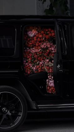 a black jeep with flowers in the trunk