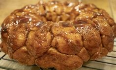 a bundt cake sitting on top of a rack covered in caramel glaze