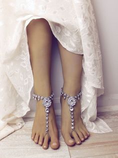 Sonia Barefoot Sandals are a beautiful addition to your next getaway. Handcrafted using stunning Kundan rhinestones, silver placed chain, adjustable closure on the back and a stunning rhinestone embedded center piece. Adorn your feet with these stunning foot chains - they look amazing on barefoot or with your favorite pair of bumps. Sold as pair, and available in silver as well as gold. All orders are processed and created in 5 to 7 business days from purchase, shipped from 7 - 12 business days Barefoot Sandals Beach Wedding, Barefoot Sandals Wedding, Rhinestone Anklet, Beach Wedding Sandals, Beach Wedding Sandals Barefoot, Beach Wedding Jewelry, Beach Wedding Shoes, Wedding Boots, Anklets Boho